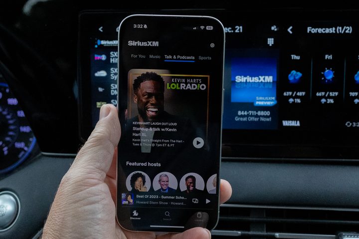 Kevin Hart's SiriusXM show as seen in the phone app in front of SiriusXM in a car.