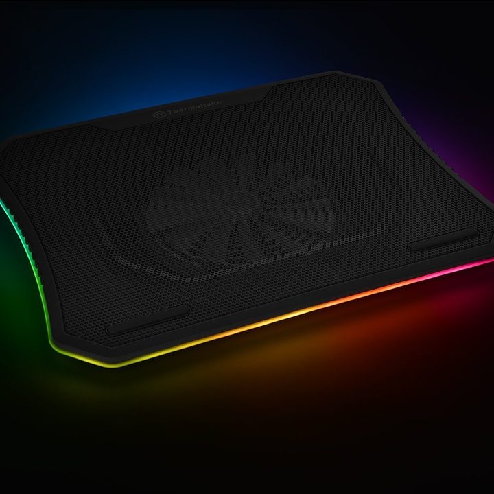 Thermaltake laptop cooling pad with RGB lighting around it.