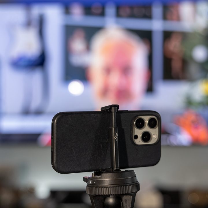 An iPhone on a Peak Design travel tripod.