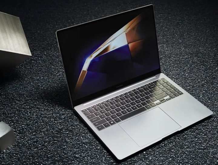 The Samsung Galaxy Book 4 Pro against a textured grey backdrop.