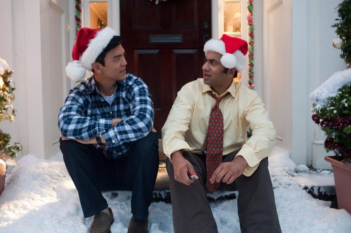 Two men in Santa hats stare at each other in A Very Kumar Christmas.