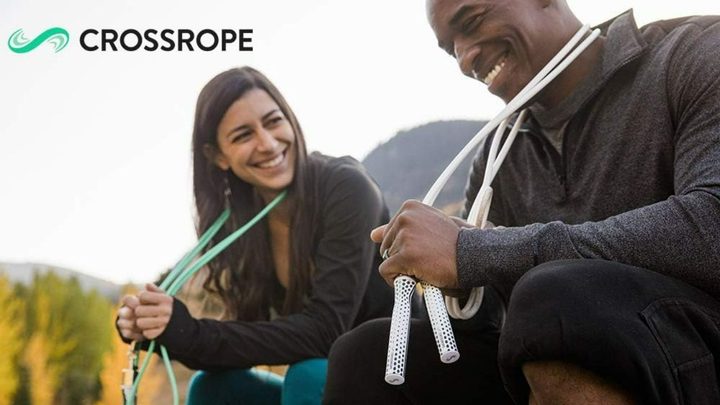 Two people on a bench holding Crossropes.