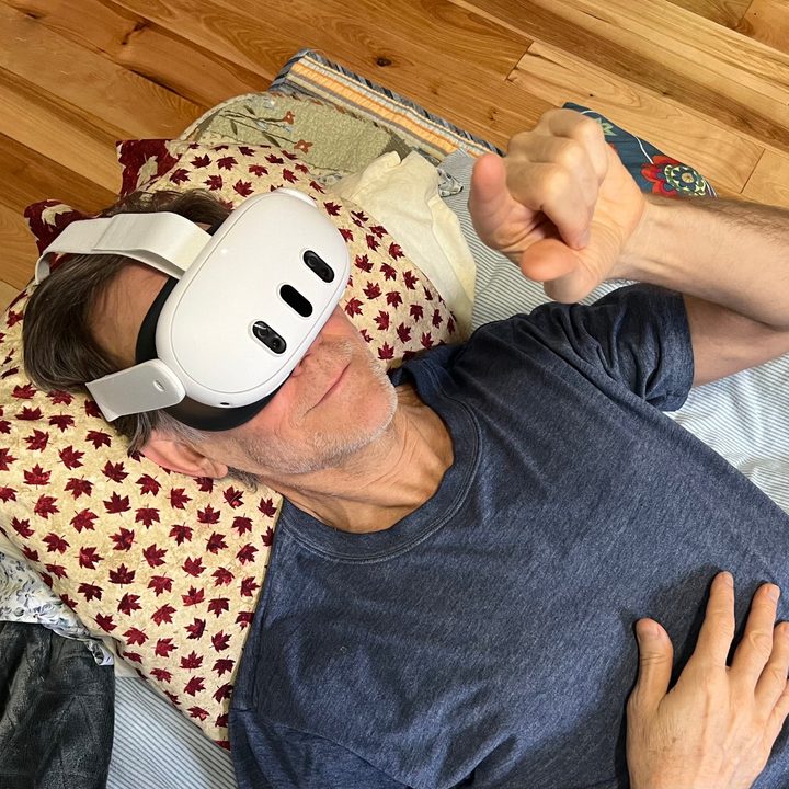 Alan Truly lays back and enjoys watching a movie in the Meta Quest 3 headset.