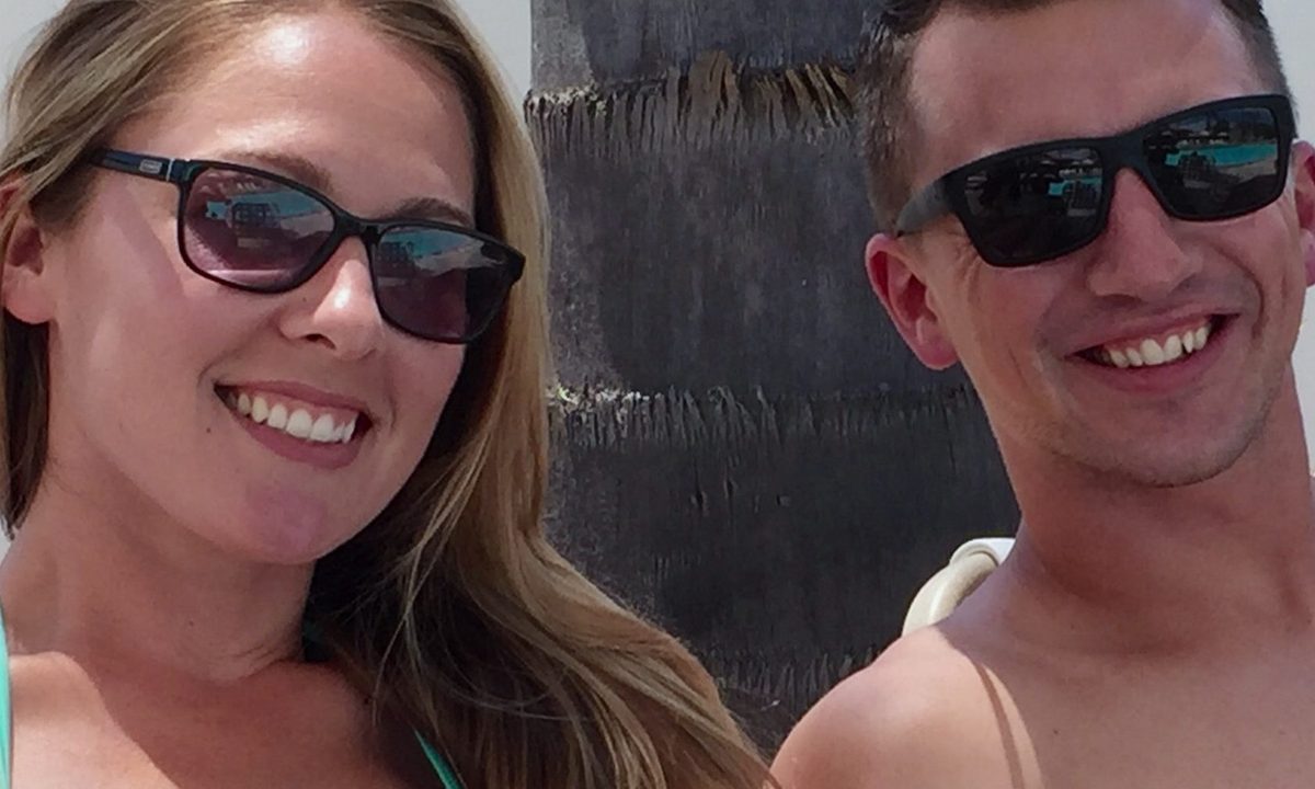 A woman and man smile and pose for a photo.