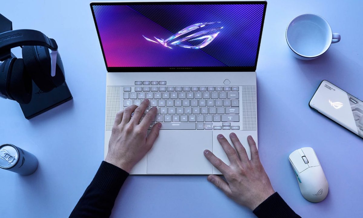 A person using the Asus ROG Zephyrus G16 laptop on a desk.