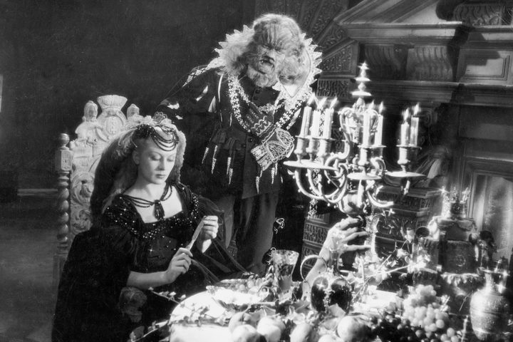 Beauty and the Beast in a dining room in La Belle et La Bête.