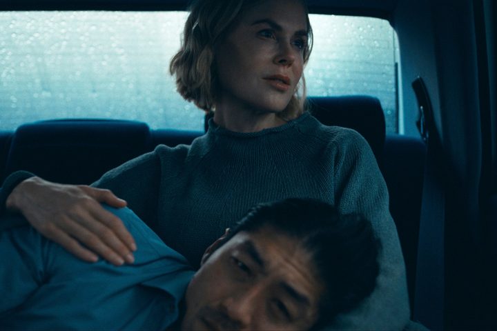 Clarke lies on Margaret's lap in Expats.