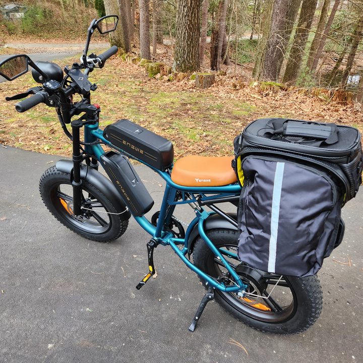 Engwe M20 e-bike with optional mirrors, phone mount, rear rack, and rack bag with panniers.