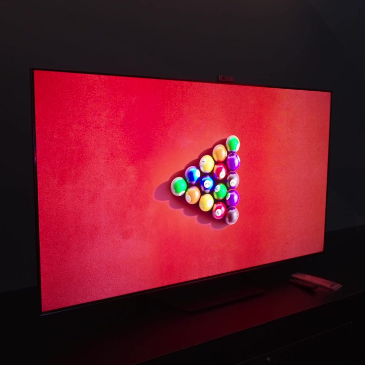 A bird's eye view of a red-felted billiard table with balls racked in the center shown on a HIsense U7N.