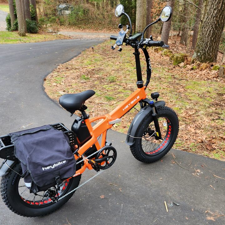 HeyBike Mars 2.0 with optional mirrors, phone mount, and panniers.