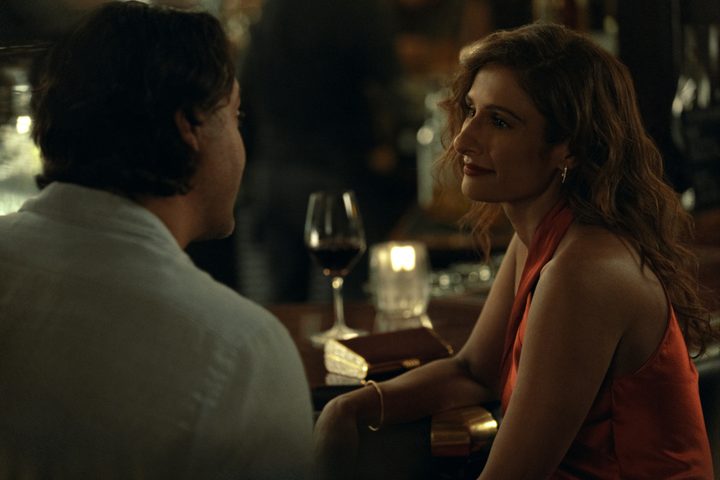Hilary sits at a bar in Expats.