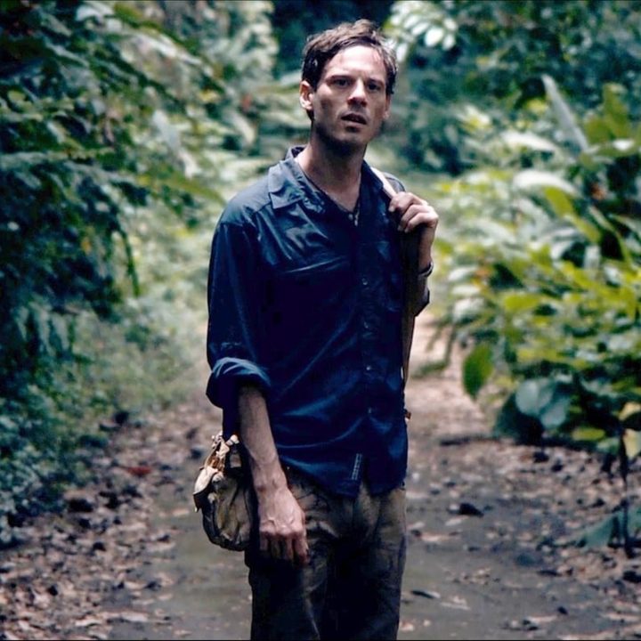 Scoot McNairy stands on a path and stares in Monsters.