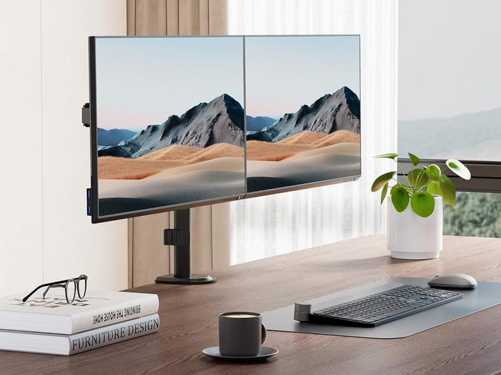 The Mount-It! Dual Monitor Arm on a desk, holding two monitors.