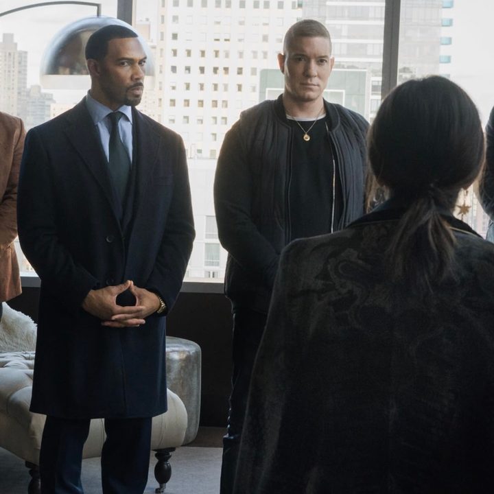 Four men stand next to each other while staring at a woman.