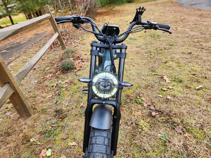 Ride1Up Revv1 left front view with optional smartphone mount on handlebars.