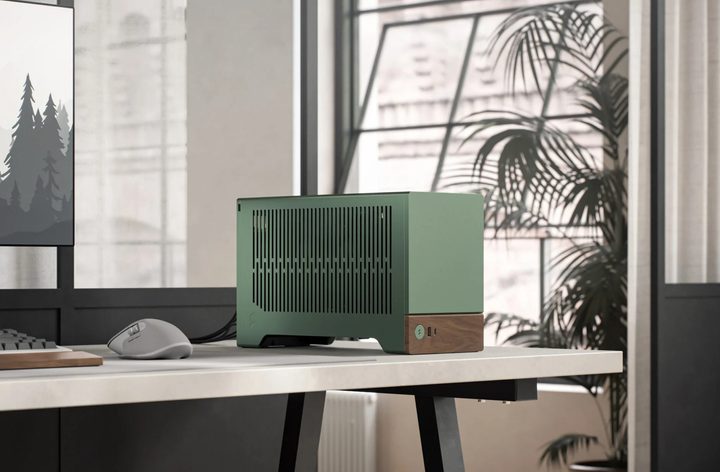 The Fractal Design Terra mini-ITX case in Jade sitting on a PC desk.