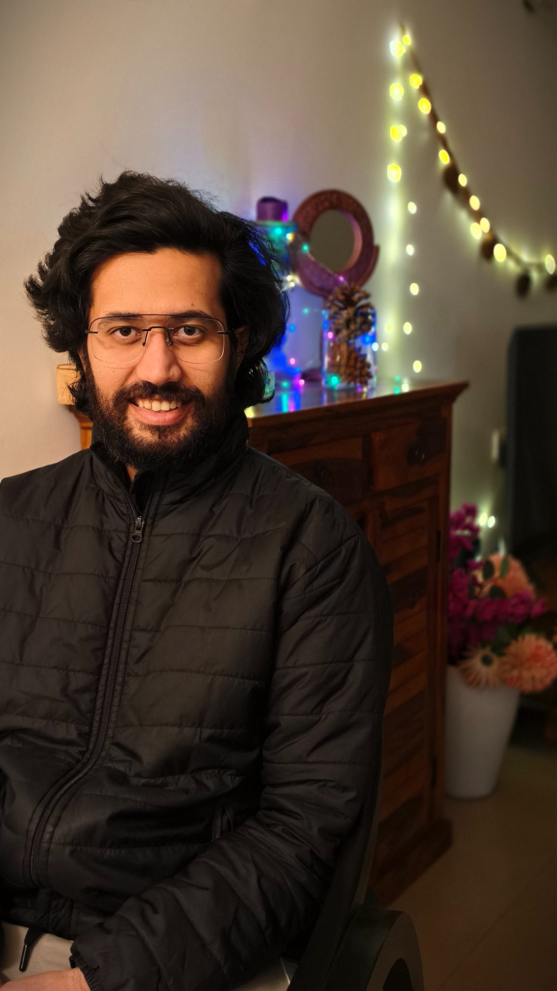 Portrait of a man wearing black bomber jacket shot on the Vivo X100's Zeiss camera.