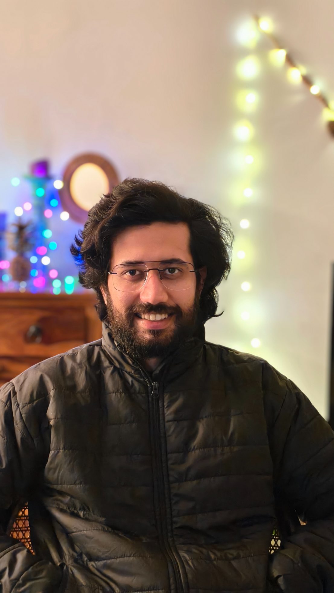 Portrait of a man wearing black bomber jacket shot on the Vivo X100's Zeiss camera.