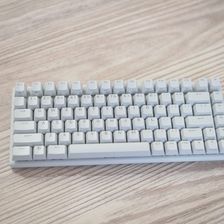The Alienware Pro Wireless Keyboard on a wooden table.
