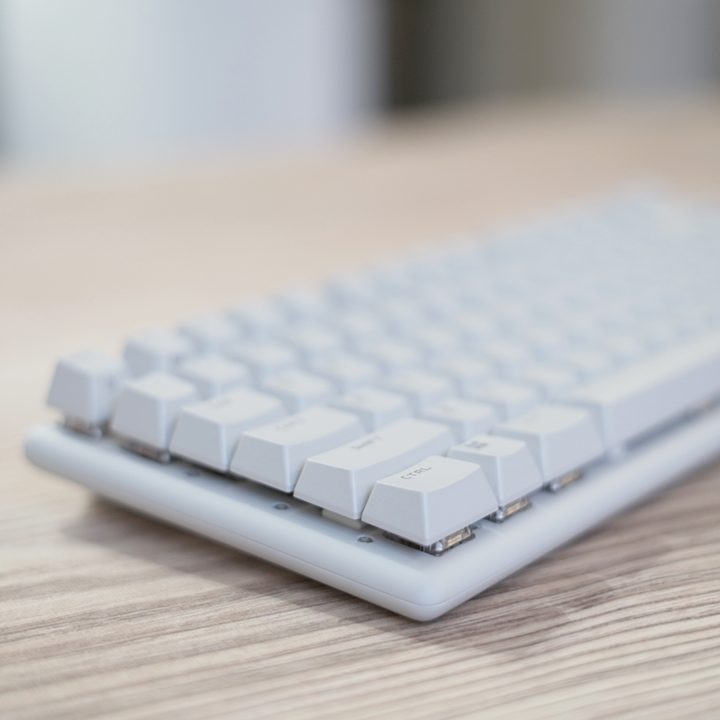 The Alienware Pro Wireless Keyboard on a wooden table.
