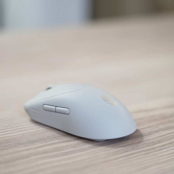The Alienware Pro Wireless Mouse on a wooden table.