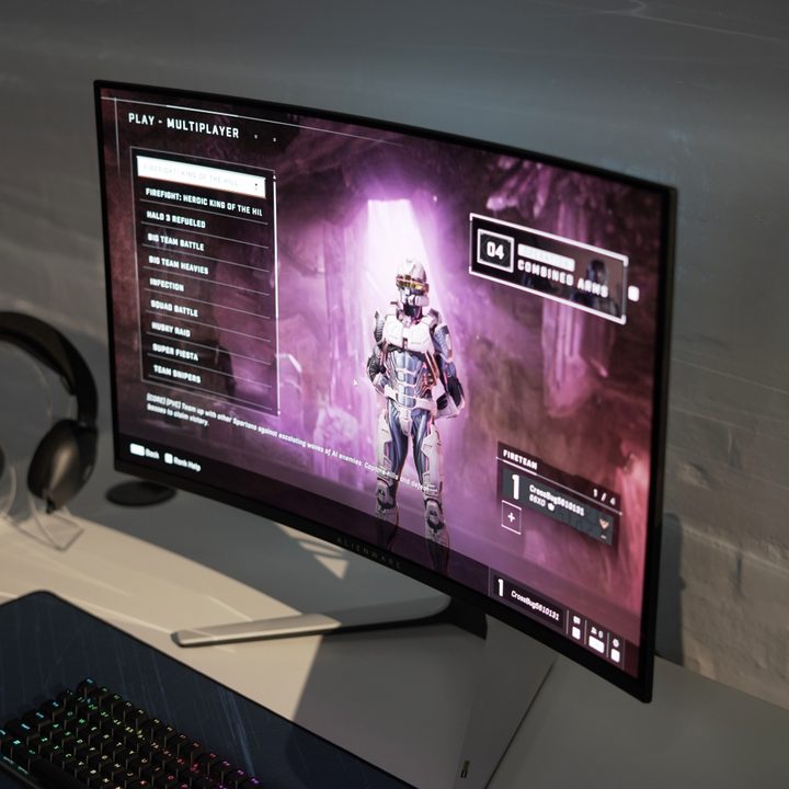 The Alienware 32 4K QD-OLED on a table with a game on the screen.