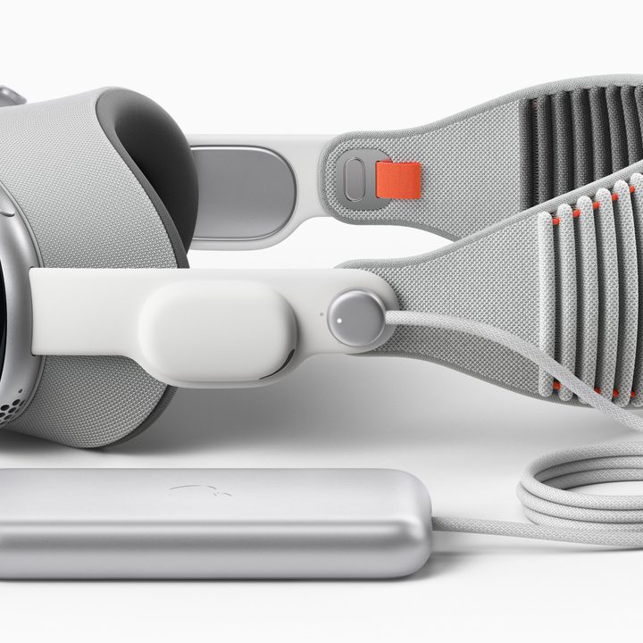 A rendering of the Vision Pro headset connected to the wired battery pack.
