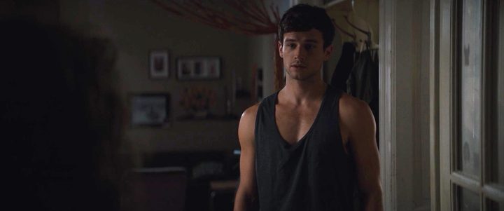 A man stands in a tank top in Hellraiser.