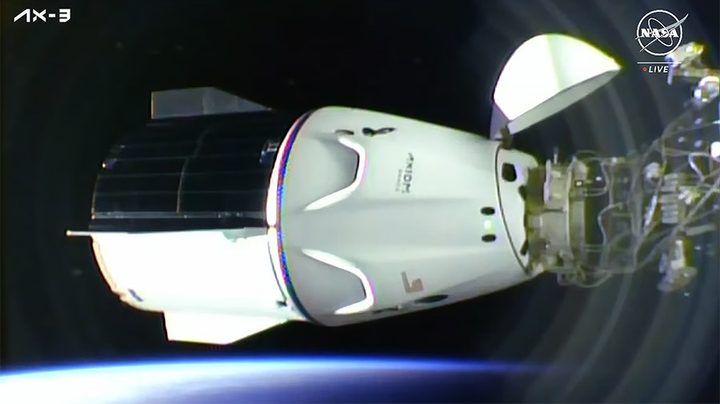 The SpaceX Dragon Freedom spacecraft carrying four Axiom MIssion 3 astronauts is pictured docked to the space station shortly after an orbital sunrise.