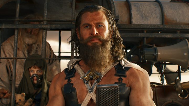 A bearded man looks ahead in Furiosa.