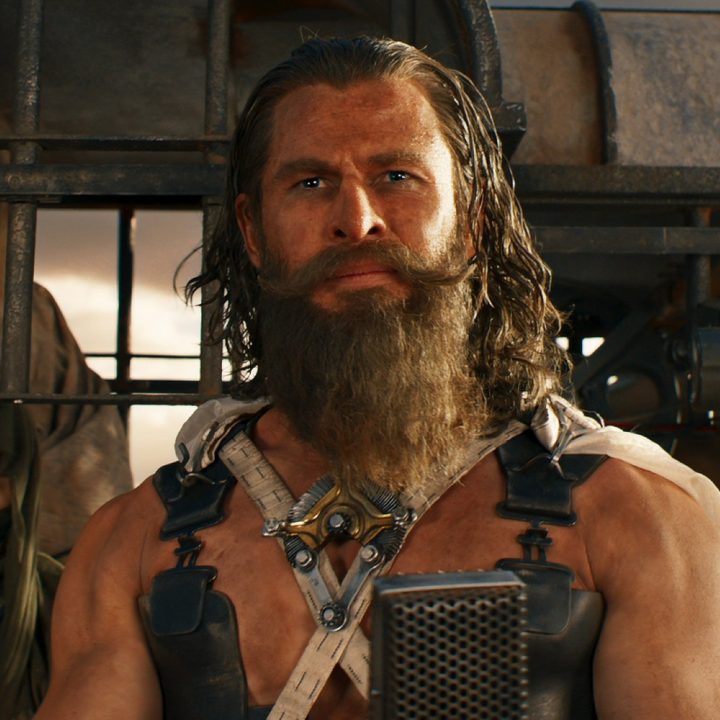 A bearded man looks ahead in Furiosa.
