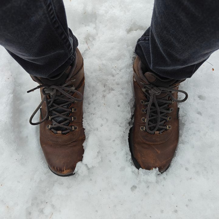 A photo of someone wearing brown boots standing in the snow, taken with the OnePlus 12R.
