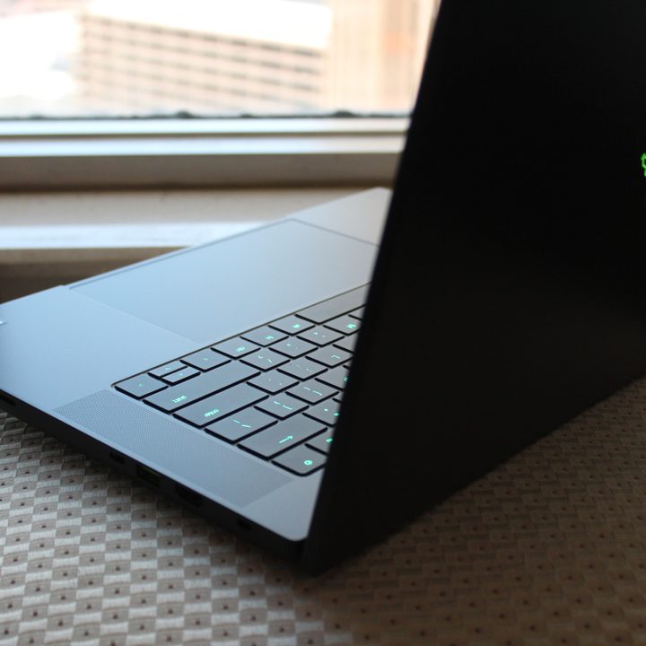 The Razer Blade 16 on a chair in front of a window.