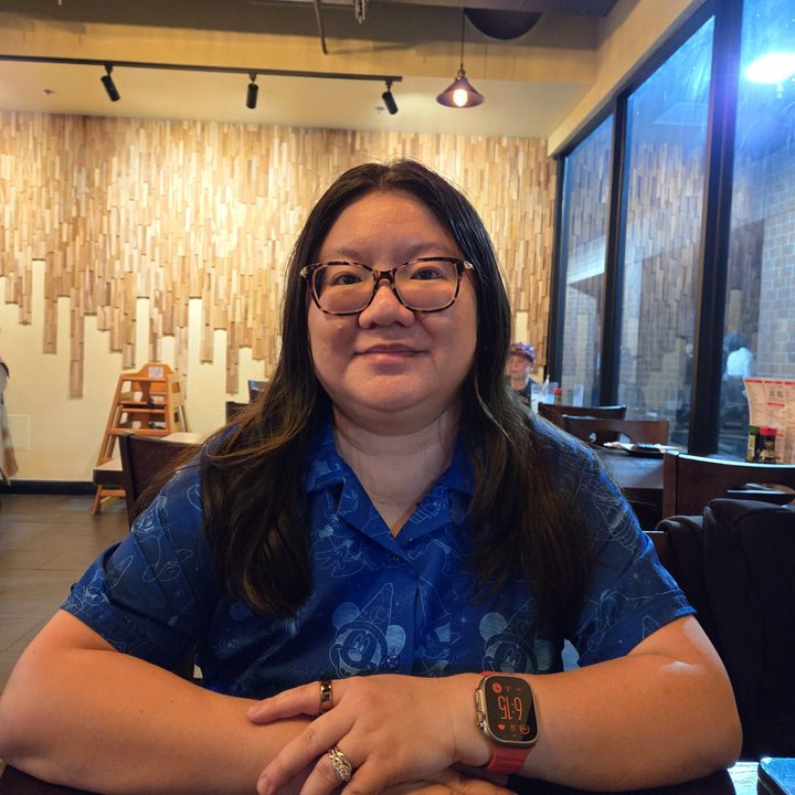 Christine posing for a photo at a restaurant taken with Samsung Galaxy S24.