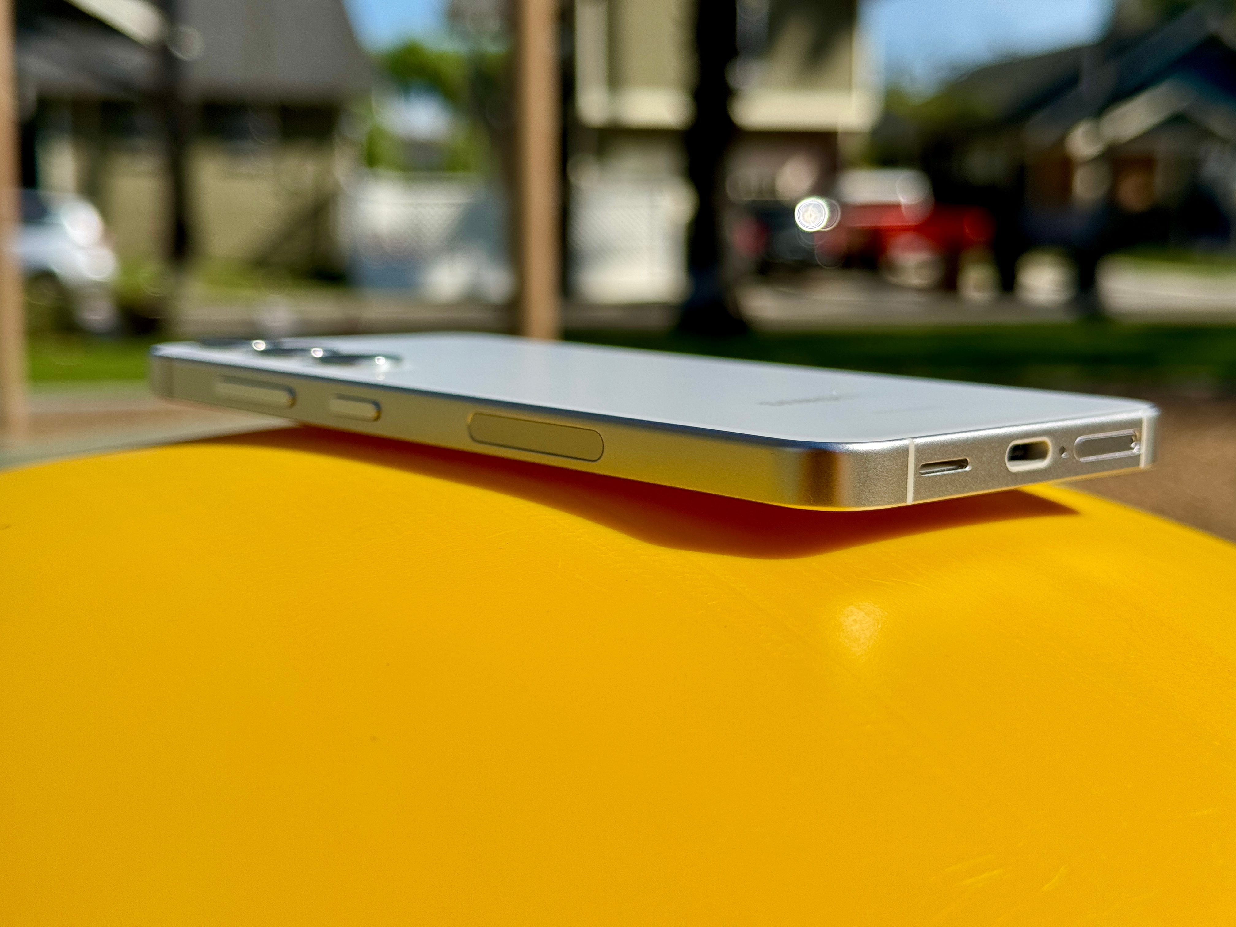 Samsung Galaxy S24 in Marble Gray laying at an angle to show flat frame.