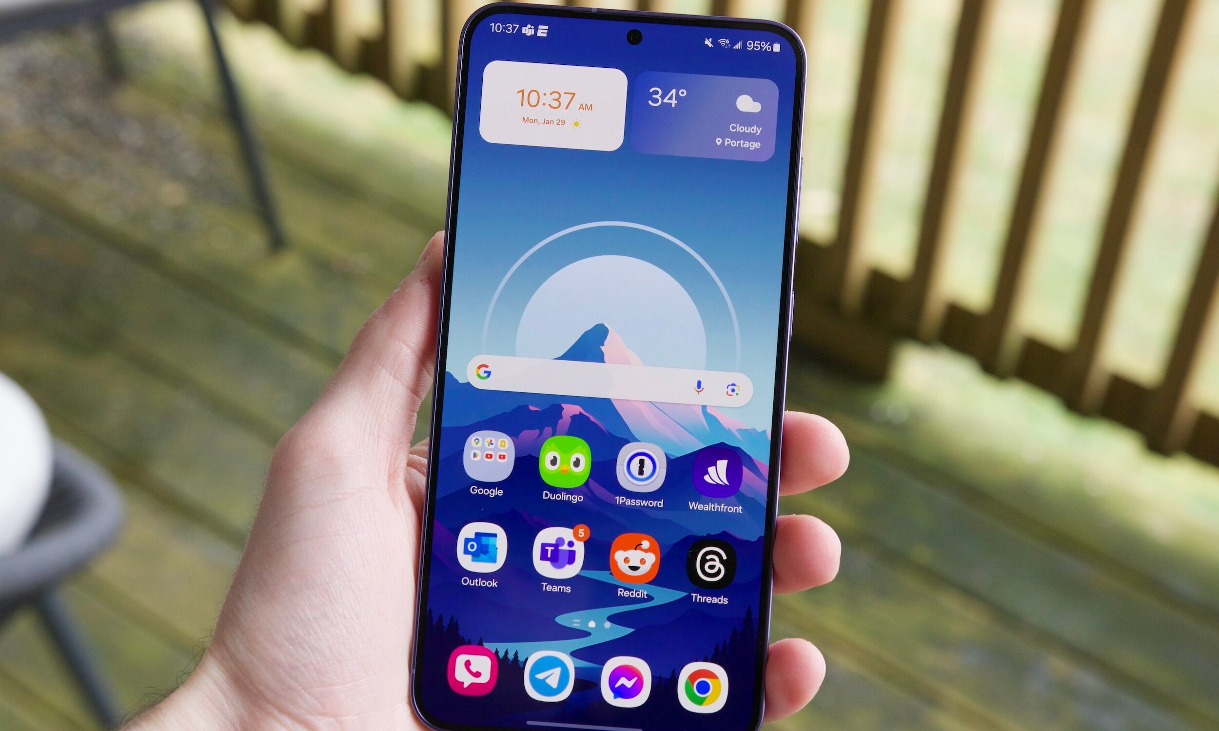 Someone holding the Samsung Galaxy S24 Plus with its screen turned on.