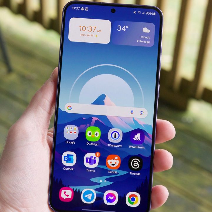 Someone holding the Samsung Galaxy S24 Plus with its screen turned on.