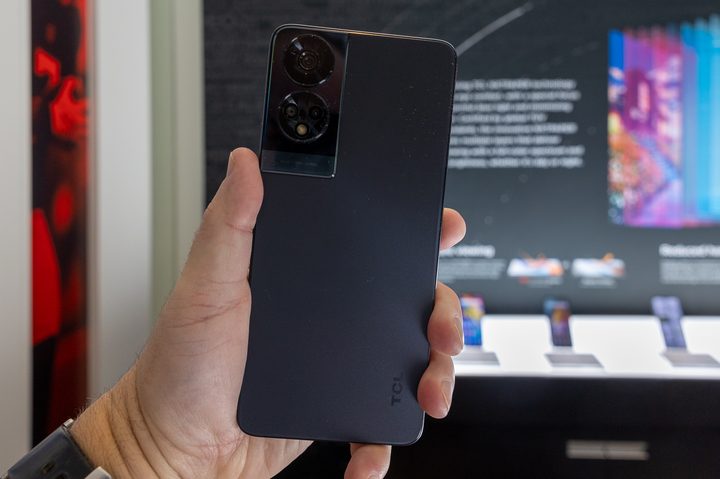 TCL 50 XE NxtPaper phone held in hand.