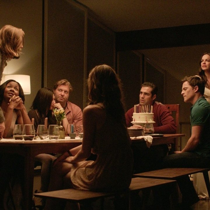 People sit at a table in The Invitation.