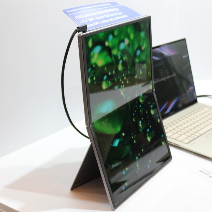 The ZenScreen Fold standed up next to a laptop.