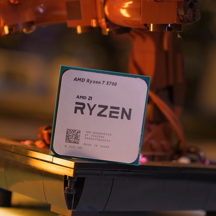 The AMD Ryzen 7 5700 propped up against an action figure.