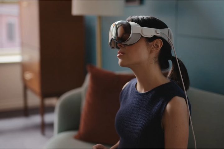 A person tilts their head while wearing the Apple Vision Pro.