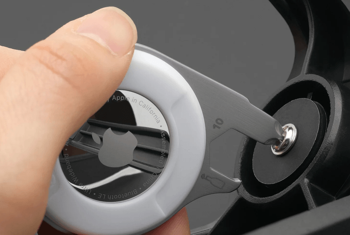 Someone using the AirTag 5-in-1 Cutter Multi-Tool.