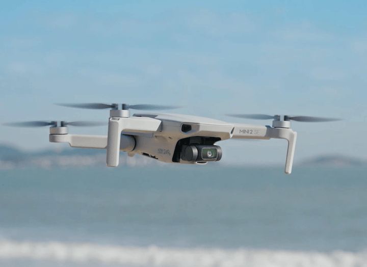 The DJI Mini 2 SE drone in flight.