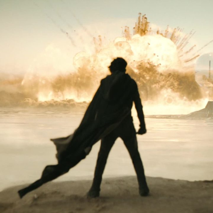 Timothée Chalamet gazes upon a distant explosion in a still from the movie Dune: Part Two.