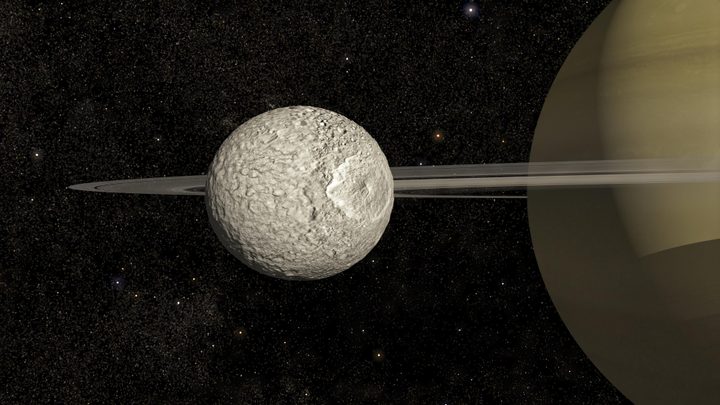 An illustration of Mimas orbiting Saturn.