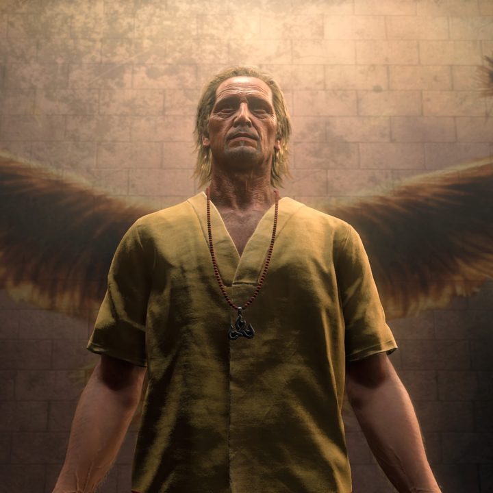 Bryce in front of angel wings. Depicting godhood with a spotlight form above showing something angelic.