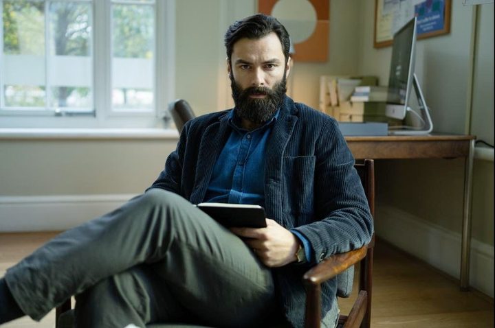A man sits in a chair in The Suspect.