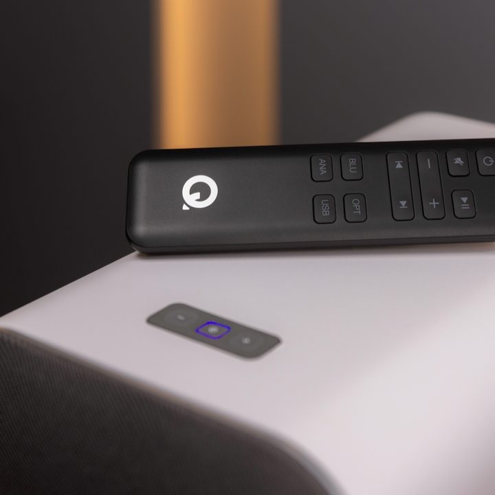 The remote on top of the Q Acoustics M40 powered micro-tower wireless audio speakers.
