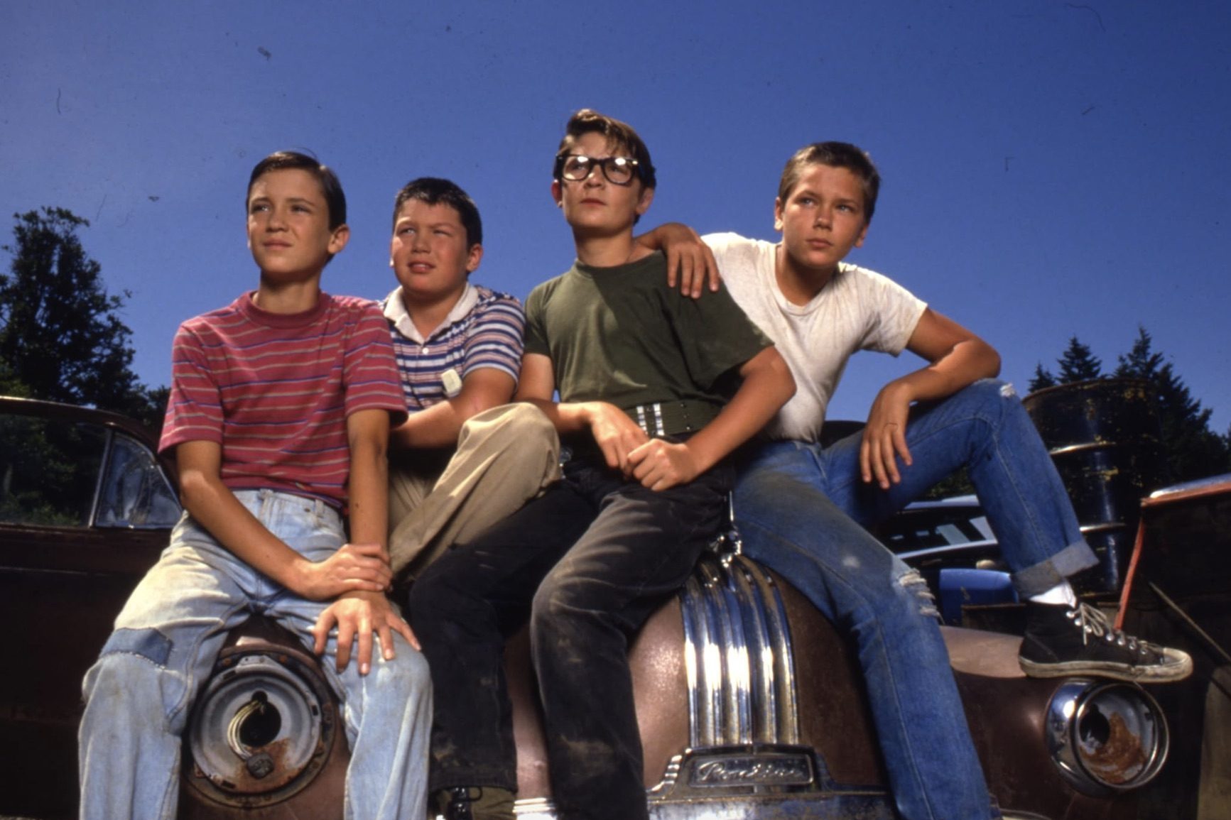 Four boys sit on the hood of a car in the film Stand By Me.